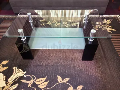 Glass Top Coffee Table with Lower Shelf and Black Pillar Legs