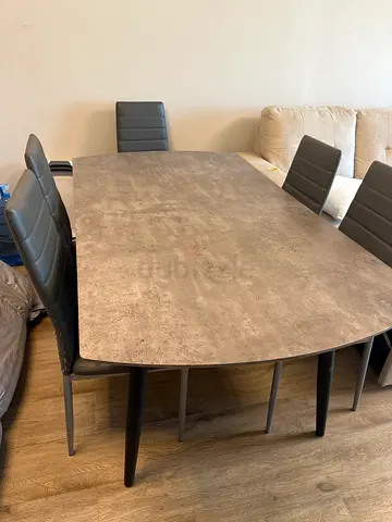 Modern concrete-look dining table with 6 padded chairs