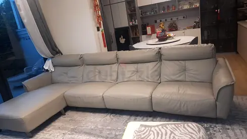 Beige leather sofa with armrest damage — for parts or repair