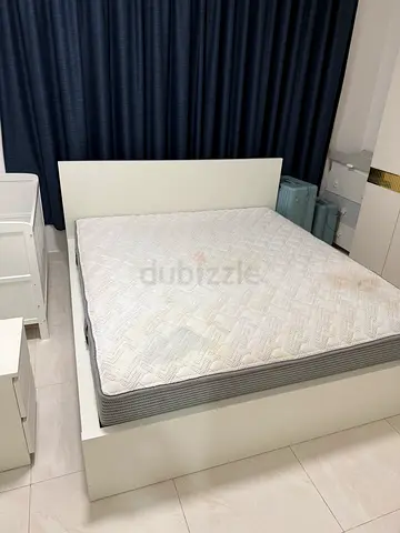 White platform bed frame with mattress and headboard - good condition
