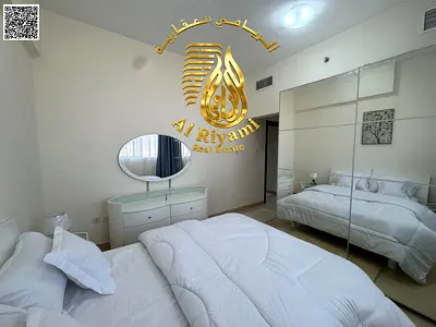 Two bedrooms and a living room, monthly rent with a balcony, including bills and parking in Al Yasmin.