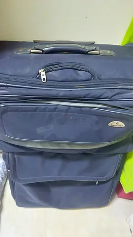 Samsonite Used navy blue soft-shell rolling suitcase with front pockets (good condition)