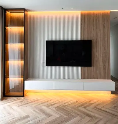 Modern wall-mounted entertainment unit with integrated display panel and lit glass cabinet