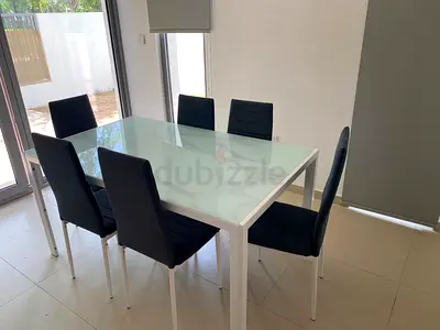 White Frame Glass-Top Dining Table with 6 Navy Padded Chairs