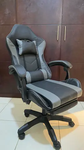 Ergonomic Grey Gaming/Office Chair with Lumbar Pillow and leg rest extension.