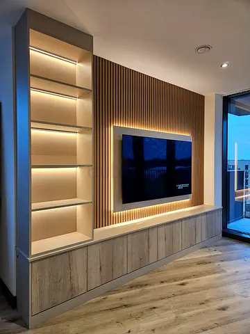 Custom built-in TV wall unit with LED shelving and storage