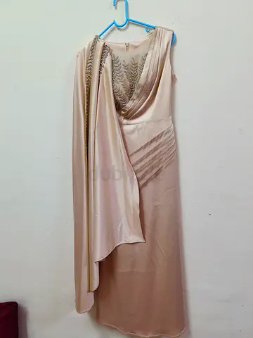 Elegant beige sleeveless evening dress with draped sash
