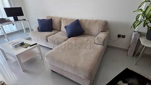 Beige L-shaped Sofa with Coffee Table - Good Condition . Pet free.