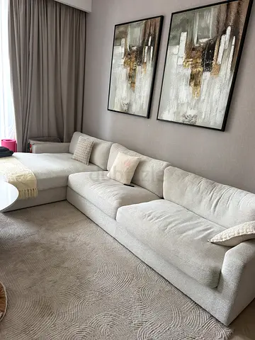 Light beige L-shaped sectional sofa with cushions