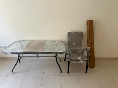 Dining table with two chairs and brand new umbrella