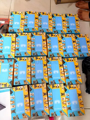 Bulk pack of unused dog puppy training pads — multiple boxes