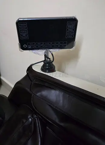 Very less Used brown leather massage chair with digital control panel.