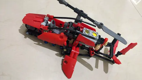 Red Lego-style Technic Helicopter Toy
