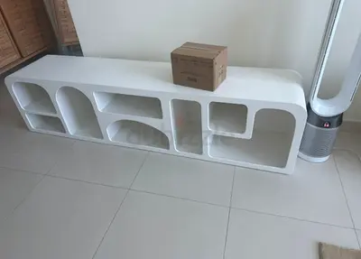 Low modern white TV / media unit with built-in shelving   table and TV unit — the white rou