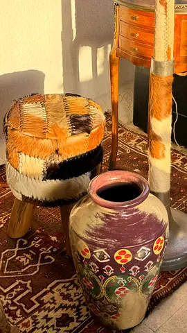 A handmade patchwork leather chair with a color-coordinated vase