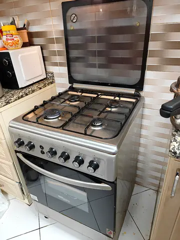 Urgent Sale-Used freestanding 4-burner gas cooker with oven - stainless steel.