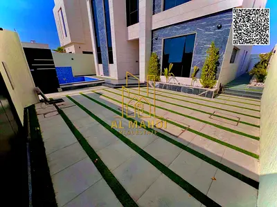 For sale, a luxury villa in a prime location in Al Alia Area Ajman, directly facing a main paved road and with direct access to Sheikh Mohammed Bin Za