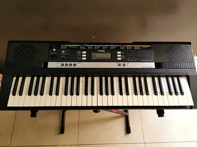 Yamaha portable keyboard - 61 keys, good working condition with stanf