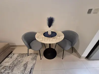 Small round marble-top bistro table with two grey chairs - compact dining set