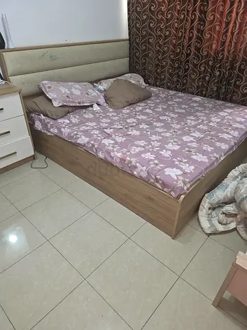 King wooden bed with upholstered headboard