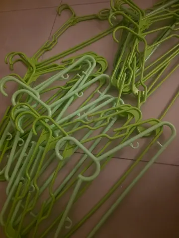 Bundle of light green plastic clothes hangers (around 30+) — excellent condition