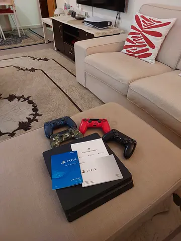 Sony PS4 Slim 1tb with 4 DualShock Controllers and Manuals - Good Condition