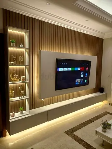 Modern wall-mounted entertainment unit with built-in shelving and LED lighting