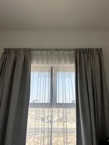 Grey blackout curtains with sheer inner panel, used