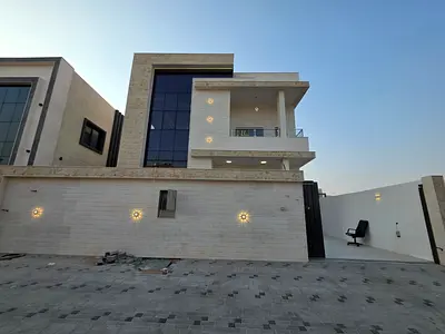 For sale, a villa in Al Zahya, Ajman, 4 master bedrooms, a living room, two halls, a kitchen with a maid's room, and a spacious yard.