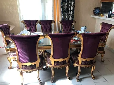 Classic carved wooden dining table with 8 purple velvet chairs
