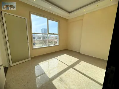Two bedrooms and a living room for annual rent in Ajman, Al Muwaihat 2 area, with parking, one month free, no deposit, and 6 post-dated checks.