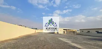 Industrial land for rent in Umm Al Quwain, 29,000 sq. ft with office, staff rooms &amp; 35 kW power.