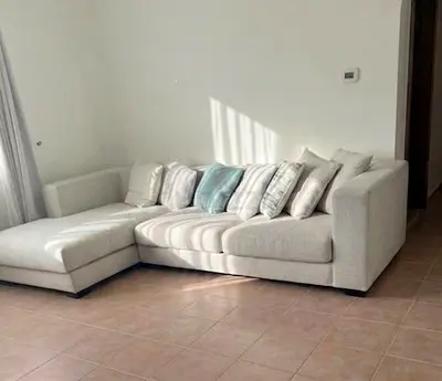 L-shaped light beige fabric corner sofa with chaise lounge - good condition