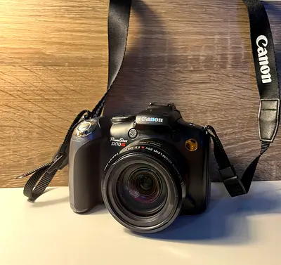 Canon PowerShot SX10 IS - Compact Superzoom Camera with Strap
