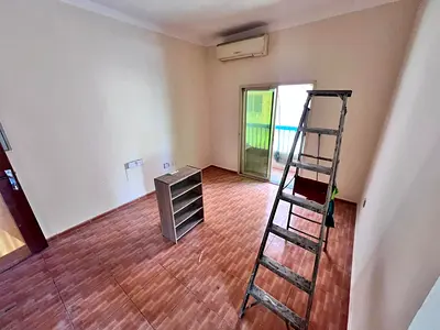 Two-bedroom apartment with a living room for annual rent in Al Rawda, Ajman, in a prime location near Sheikh Mohammed Bin Zayed exit and close to Kenz