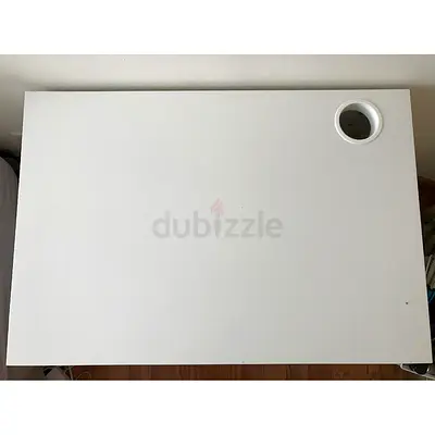 White minimalist study table with cable grommet