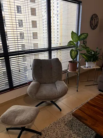 Grey swivel lounge chair with matching ottoman - good condition