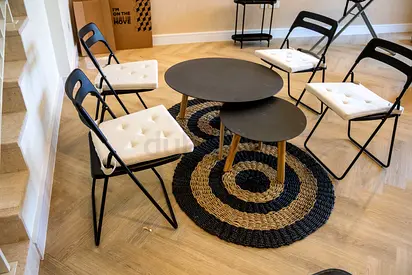 Modern Round Coffee Table with 4 Folding Chairs - Black Top, White Cushions