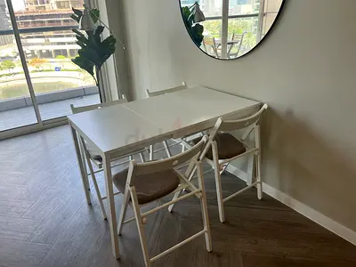 Compact White Dining Table with 4 Folding Chairs - Good Condition
