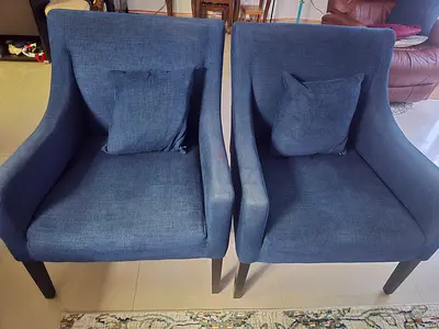 Pair of navy blue fabric accent chairs with cushions fr9m The One for 150 Aed for both.