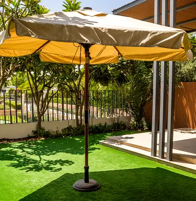 Used outdoor patio umbrella with weighted base — folding, wooden pole