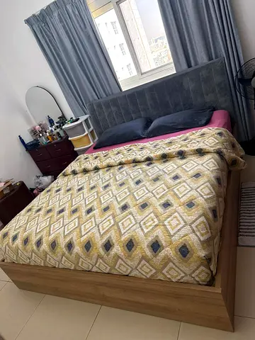 Queen bed with upholstered headboard and wooden frame