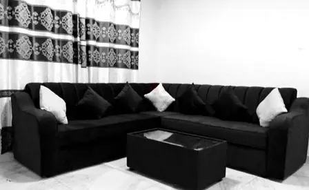 L-shaped Black Fabric Sofa with Cushions —