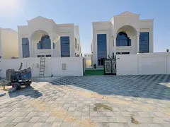 For sale in Al Helio 2, Ajman: a villa with 5 master bedrooms, a majlis, two living rooms, a kitchen