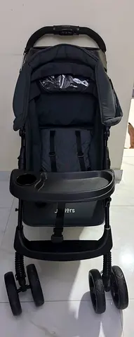 Used black baby stroller with tray and canopy - good condition