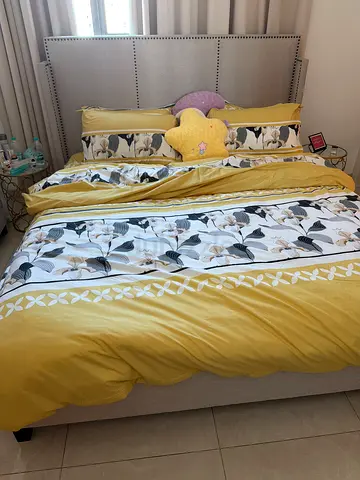 Queen bed with mattress and yellow floral bedding