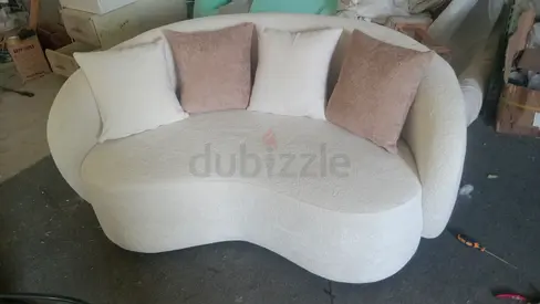 Curved Cream Two-Seater Sofa with 5 Cushions -