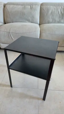 Simple black metal side table with lower shelf