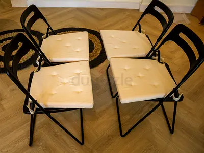 Modern Round Coffee Table with 4 Folding Chairs - Black Top, White Cushions