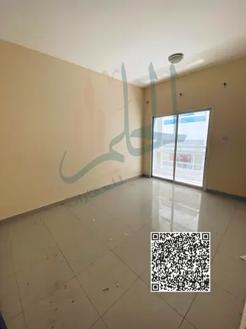 For annual rent in Al Hamidiya: a one-bedroom apartment with a living room and a spacious balcony, featuring central air conditioning, with flexible p
